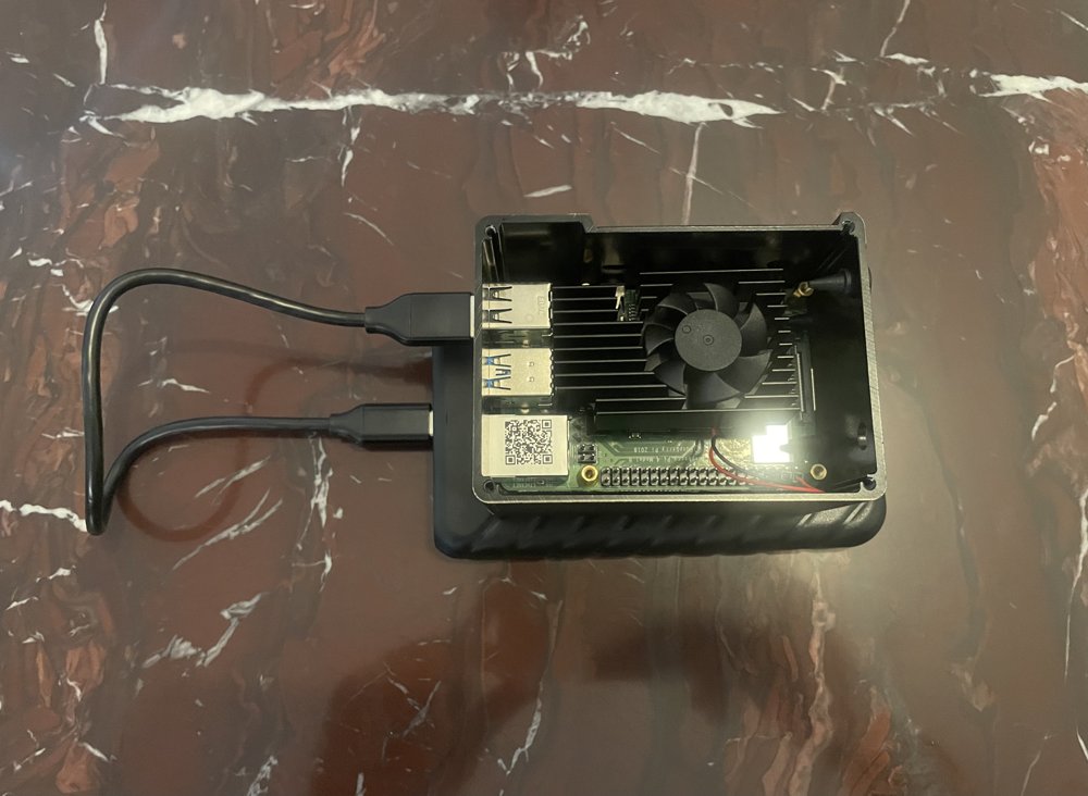 Closed SSD enclosure connected via USB cable to the Raspberry Pi's USB port