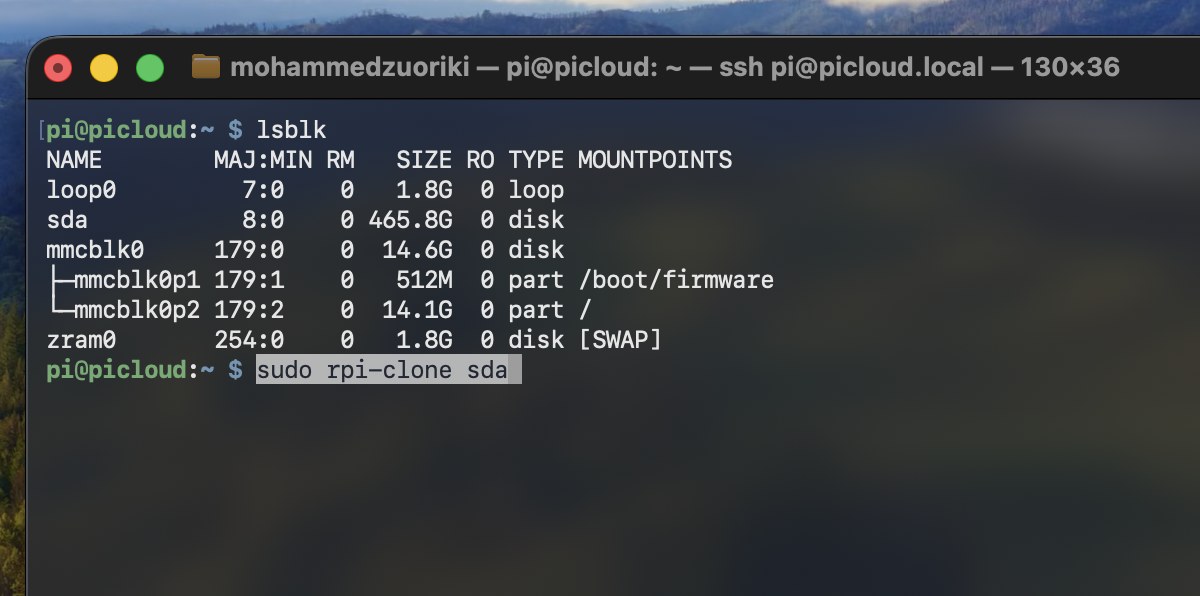 Terminal showing lsblk output listing sda (the SSD) and mmcblk0 (the SD card), with the sudo rpi-clone sda command typed and ready